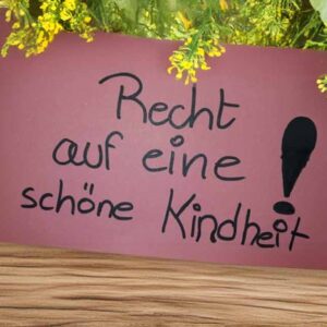Schild mit der Aufschrift: Recht auf eine schöne Kindheit